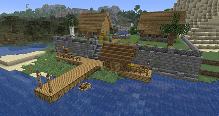 Village on a raised terrace behind a stone brick wall, with stairs down to a wooden dock and a fishing hut