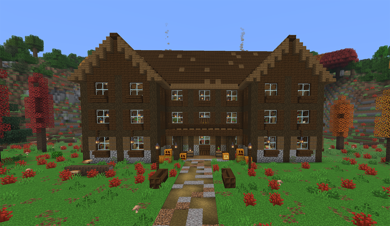 Dark oak wooden mansion in Minecraft with three floors standing in a dappled forest of red, orange, and yellow poplar trees with pumpkins on the porch