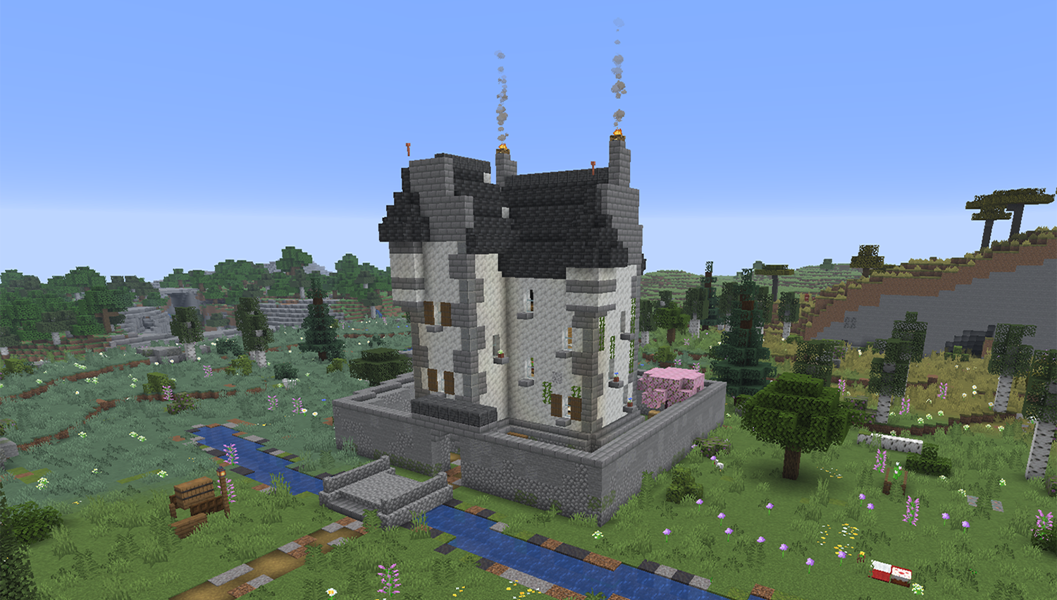 Small white tower Minecraft castle with a walled yard and a bridge