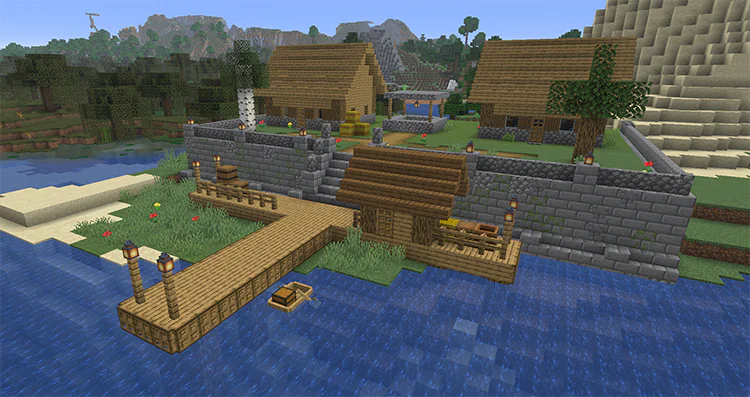 Village on a raised terrace behind a stone brick wall, with stairs down to a wooden dock and a fishing hut