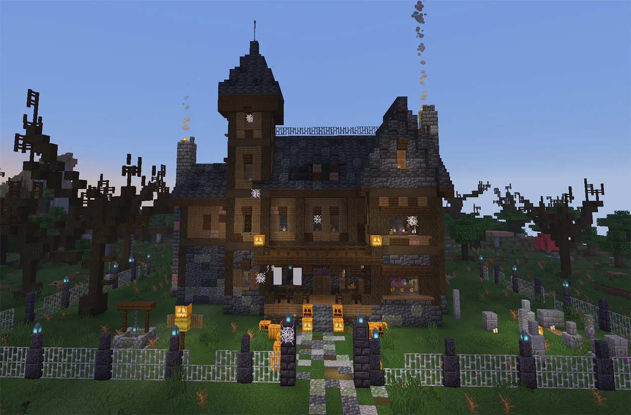 Haunted house in Minecraft with a tall tower, balcony, iron fence, and graves