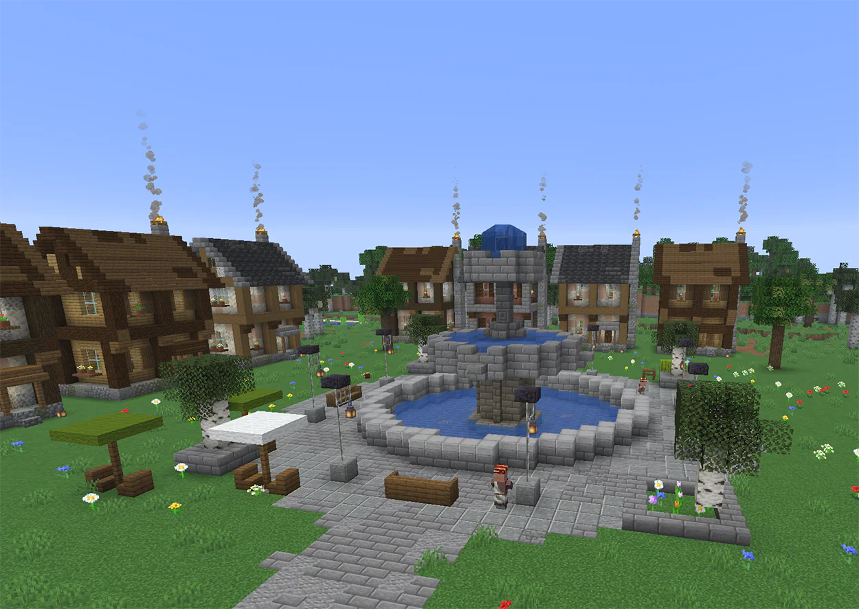 Minecraft tiered stone fountain in a town square with shops and cafe tables