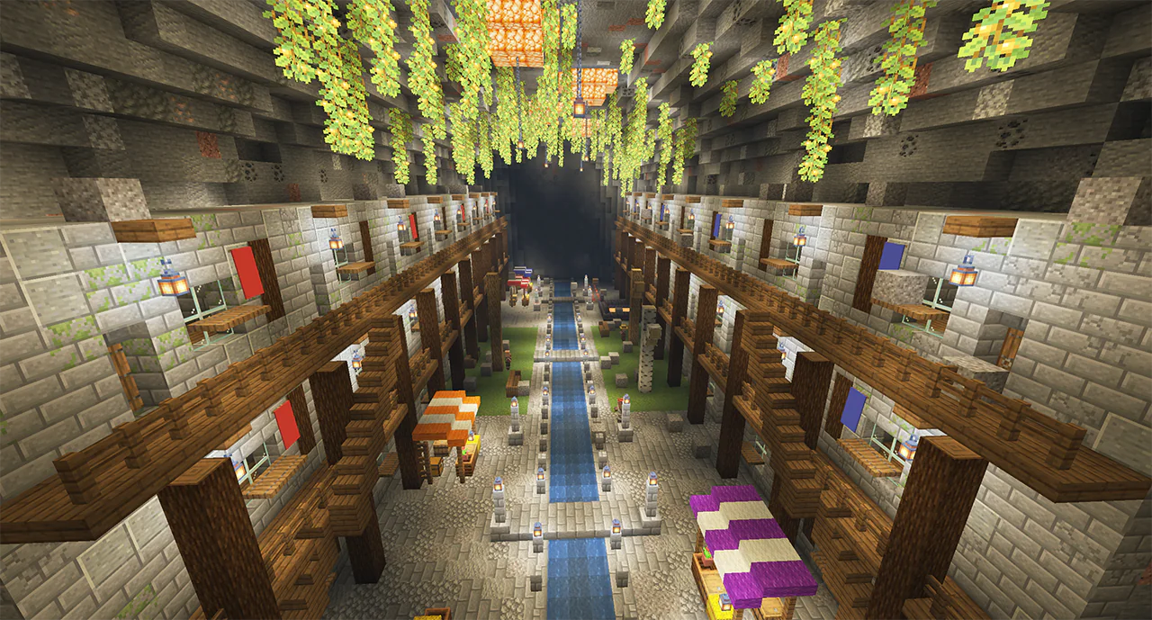 Minecraft underground city in a ravine with carved stone houses, walkways and a river